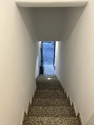 a stairway leading up to a room with white walls at Private 1 bedroom house in Machico Centre in Machico