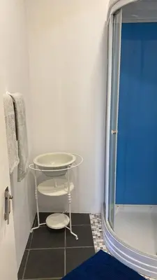 a bathroom with a shower and a glass table at La casita de campo in Ponta do Sol
