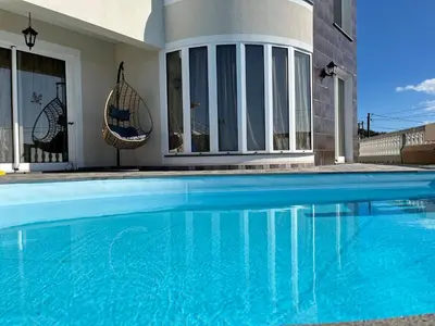 a swimming pool in front of a house at La casita de campo in Ponta do Sol