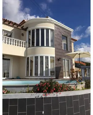 a house with a swimming pool in front of it at La casita de campo in Ponta do Sol