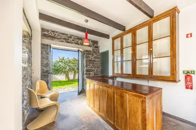 a room with a wooden counter and a window at Calheta Traditional in Arco da Calheta