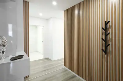 a room with a wooden partition with a mirror at Holiday Beach in Machico