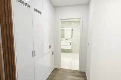 a white bathroom with a sink and a mirror at Holiday Beach in Machico