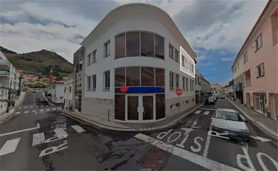 a building on a street with a car parked in front at Holiday Beach in Machico