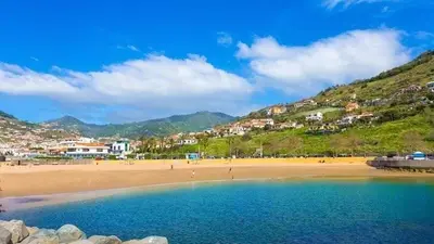 a view of a beach with people on it at Holiday Beach in Machico