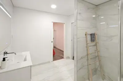a bathroom with a sink and a glass shower at Holiday Beach in Machico