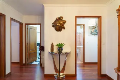 a hallway with a table in the middle of a room at GuestReady - Breathtaking seaview in Caniço in Caniço