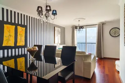 a living room with a dining table and a couch at GuestReady - Breathtaking seaview in Caniço in Caniço
