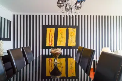 a dining room with a table with a vase on it at GuestReady - Breathtaking seaview in Caniço in Caniço