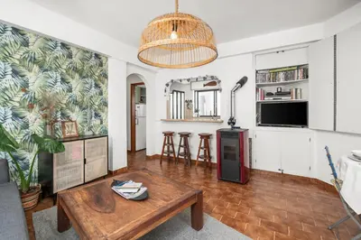 a living room with a coffee table and a tv at Burgau Fisherman's Cottage in Burgau