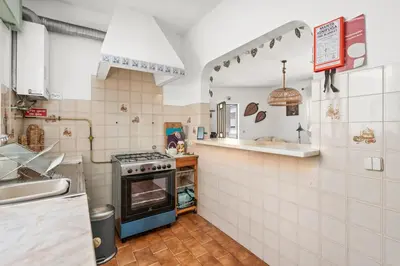 a kitchen with a stove and a sink at Burgau Fisherman's Cottage in Burgau