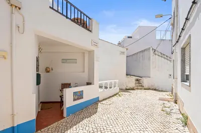 a courtyard in a house with white walls at Burgau Fisherman's Cottage in Burgau