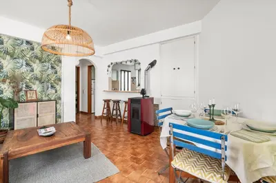 a living room with a table and a dining room at Burgau Fisherman's Cottage in Burgau