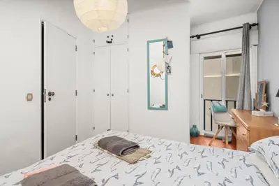 a bedroom with a bed and a desk and a mirror at Casa Indie in Burgau