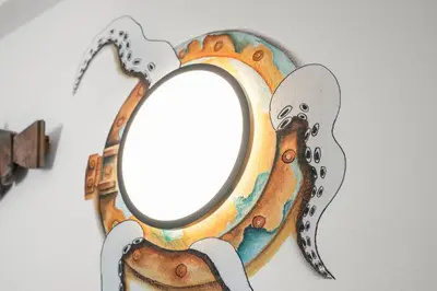a mirror with a picture of a dog on a wall at Casa Indie in Burgau