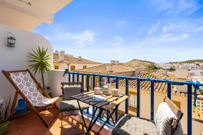 a balcony with a table and chairs and a view at Casa Indie in Burgau