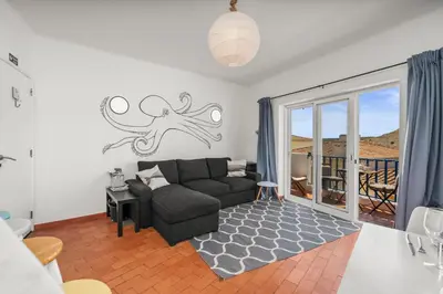 a living room with an octopus on the wall at Casa Indie in Burgau