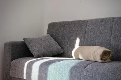 a pillow on a couch in a living room at Like Home I - vista mar e ambiente relaxante in Funchal