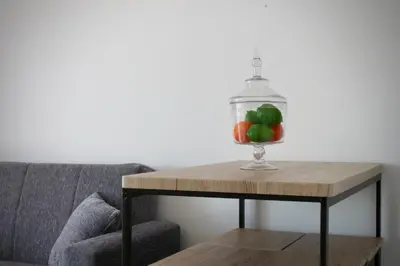 a glass bowl of apples on a table next to a couch at Like Home I - vista mar e ambiente relaxante in Funchal