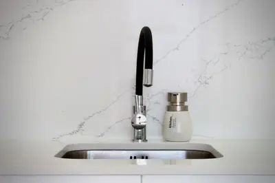 a kitchen sink with a faucet on top of it at Like Home II - casa espaçosa com 3 quartos e vista mar in Funchal