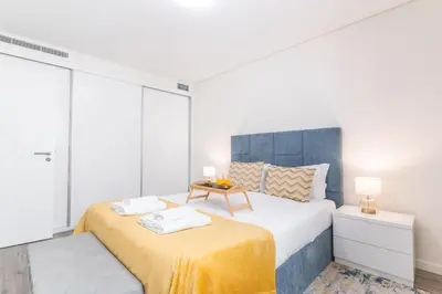 a bedroom with a large bed with a table on it at Funchal Essence by Atlantic Holiday in Funchal