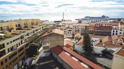 an aerial view of a city with buildings and a cruise ship at Funchal Essence by Atlantic Holiday in Funchal