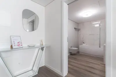 a white bathroom with a sink and a mirror at Funchal Essence by Atlantic Holiday in Funchal