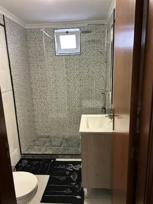 a bathroom with a shower and a toilet and a sink at Caniço Easy Stay in Caniço