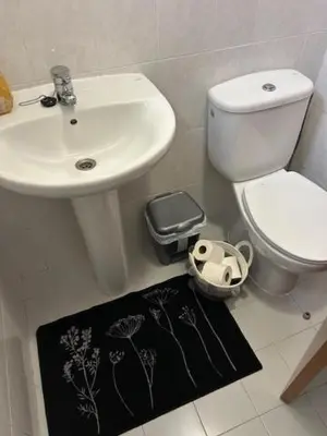 a bathroom with a sink and a toilet and a bidet at Caniço Easy Stay in Caniço