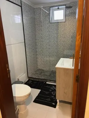 a bathroom with a shower and a toilet and a sink at Caniço Easy Stay in Caniço
