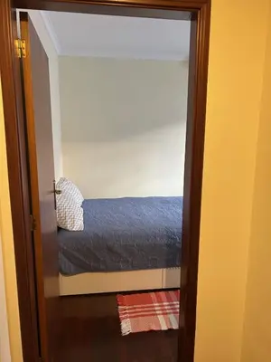 a door leading to a bed in a room at Caniço Easy Stay in Caniço