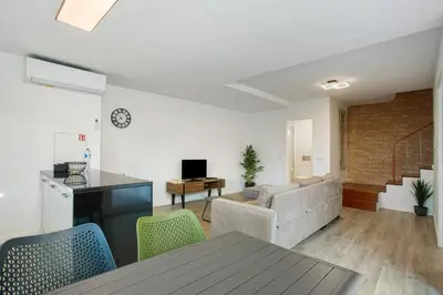 a living room with a couch and a table at Casa Do Tempo com Jacuzzi in Ribeira Brava