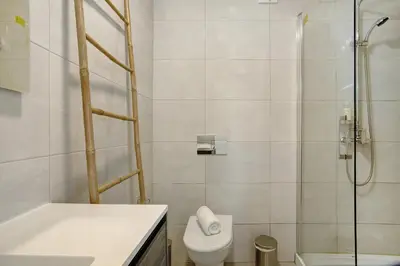 a bathroom with a shower and a toilet and a sink at Casa Do Tempo com Jacuzzi in Ribeira Brava