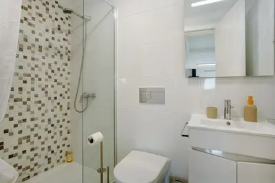 a bathroom with a toilet and a glass shower at Casa Do Tempo com Jacuzzi in Ribeira Brava