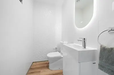 a white bathroom with a sink and a toilet at Peace Haven III in Câmara de Lobos
