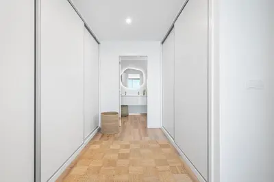 an empty hallway with white walls and a wood floor at Peace Haven III in Câmara de Lobos
