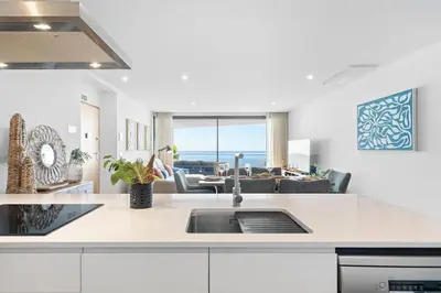 a kitchen with a sink and a living room at Peace Haven III in Câmara de Lobos