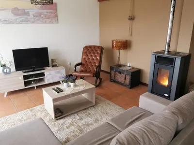 a living room with a couch and a wood stove at House in the montain Casa do Cabeço in Machico