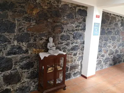 a corner of a room with a stone wall at House in the montain Casa do Cabeço in Machico