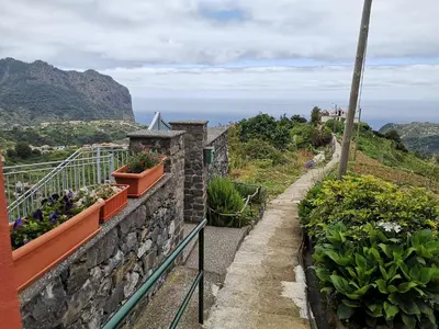 a balcony with plants and flowers on a mountain at House in the montain Casa do Cabeço in Machico