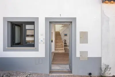 a hallway of a white house with a doorway at Casa do Bispo in Vila do Bispo