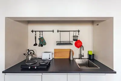 a kitchen with a black counter top and a sink at Casa do Bispo in Vila do Bispo