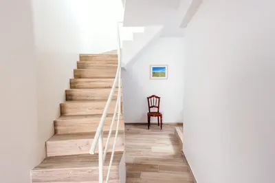 a staircase in a house with white walls and wooden floors at Casa do Bispo in Vila do Bispo