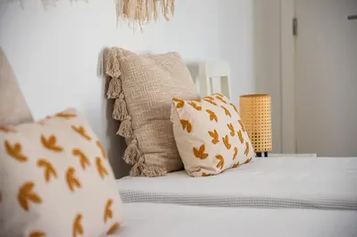 a bedroom with a bed with pillows on it at Casa do Bispo in Vila do Bispo