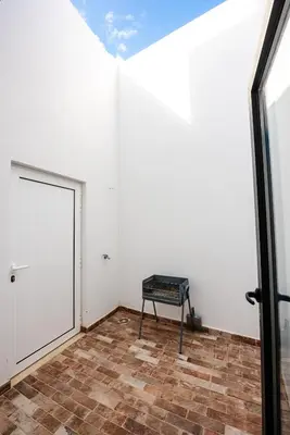 a room with a door and a bench in it at Casa do Bispo in Vila do Bispo