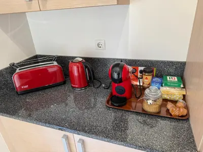 a kitchen counter with a red appliance on a cutting board at Praia da Luz - Resort in Luz