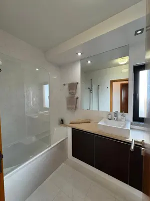 a bathroom with a sink and a tub and a mirror at Praia da Luz - Resort in Luz