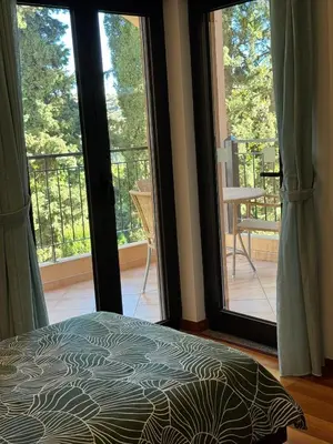 a bedroom with a bed and sliding glass doors at Praia da Luz - Resort in Luz