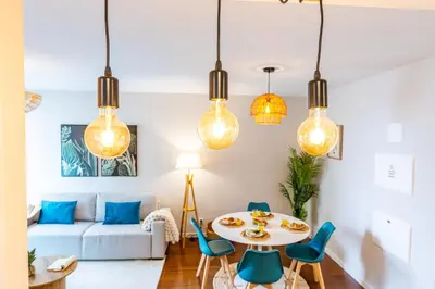 a living room with a table and chairs and lights at Formosa Stay IV by YOUR KEY in Funchal