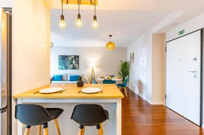 a kitchen with a island with two chairs and a table at Formosa Stay IV by YOUR KEY in Funchal